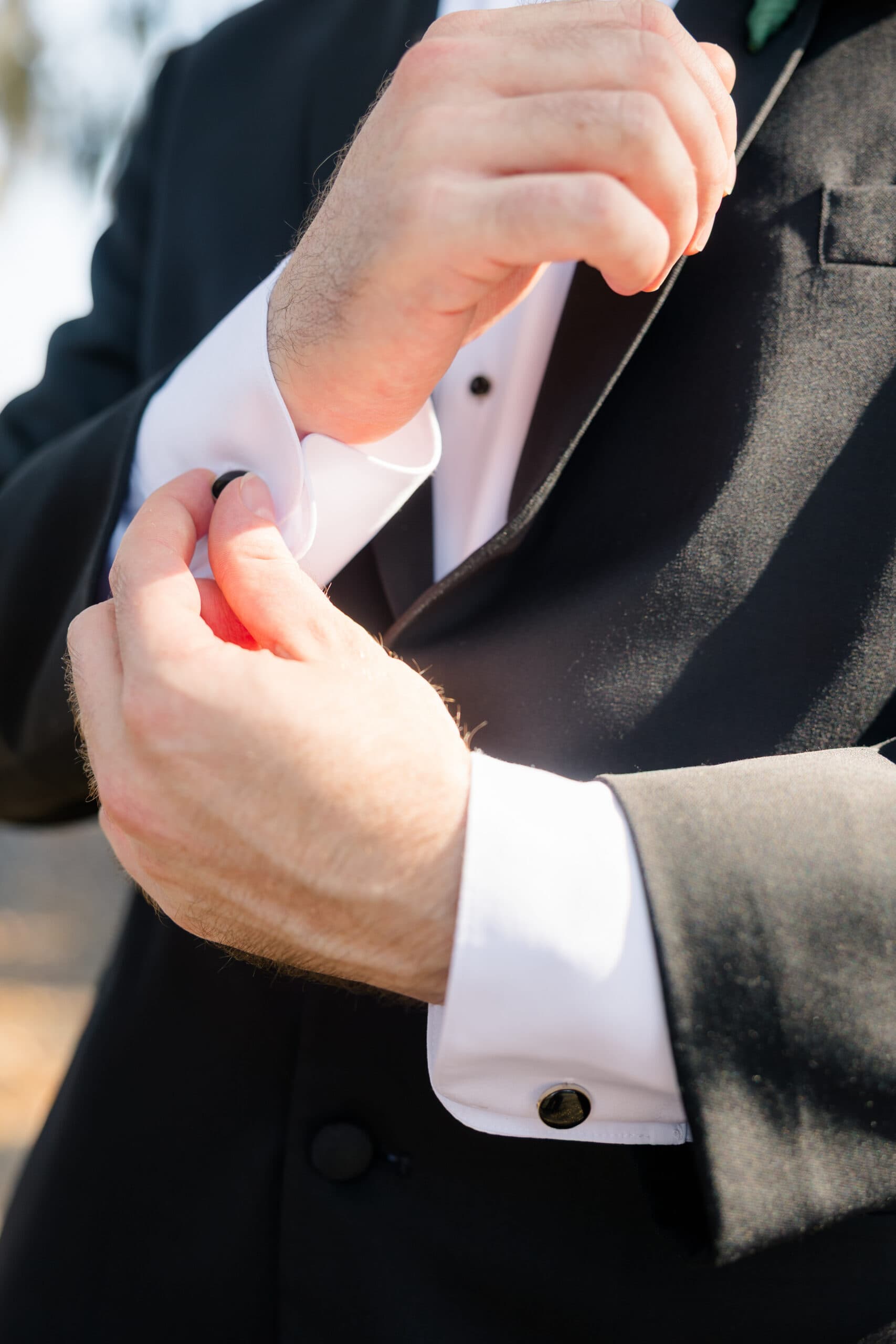 Groom fastening his cufflinks