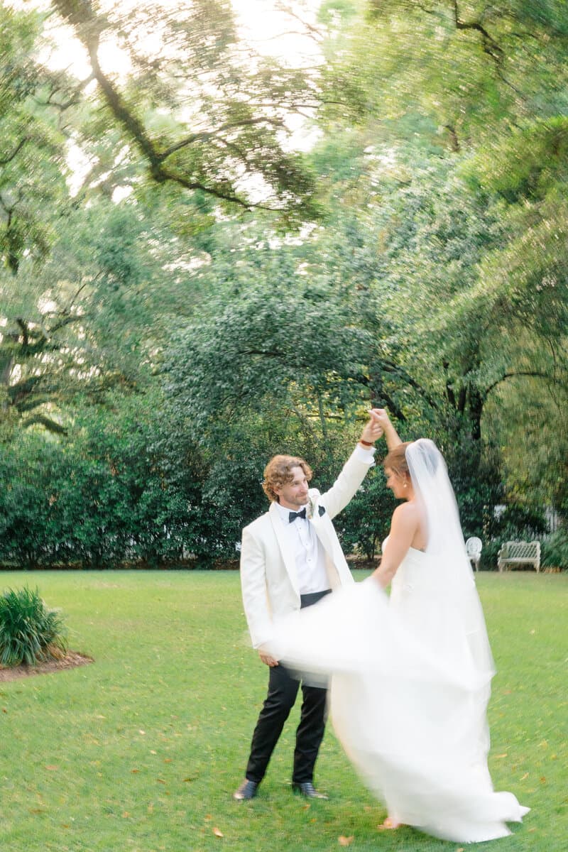 Bride and groom dancing beneath the oak trees