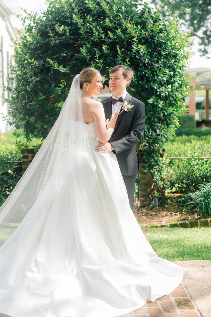 Bride and groom embracing in a garden