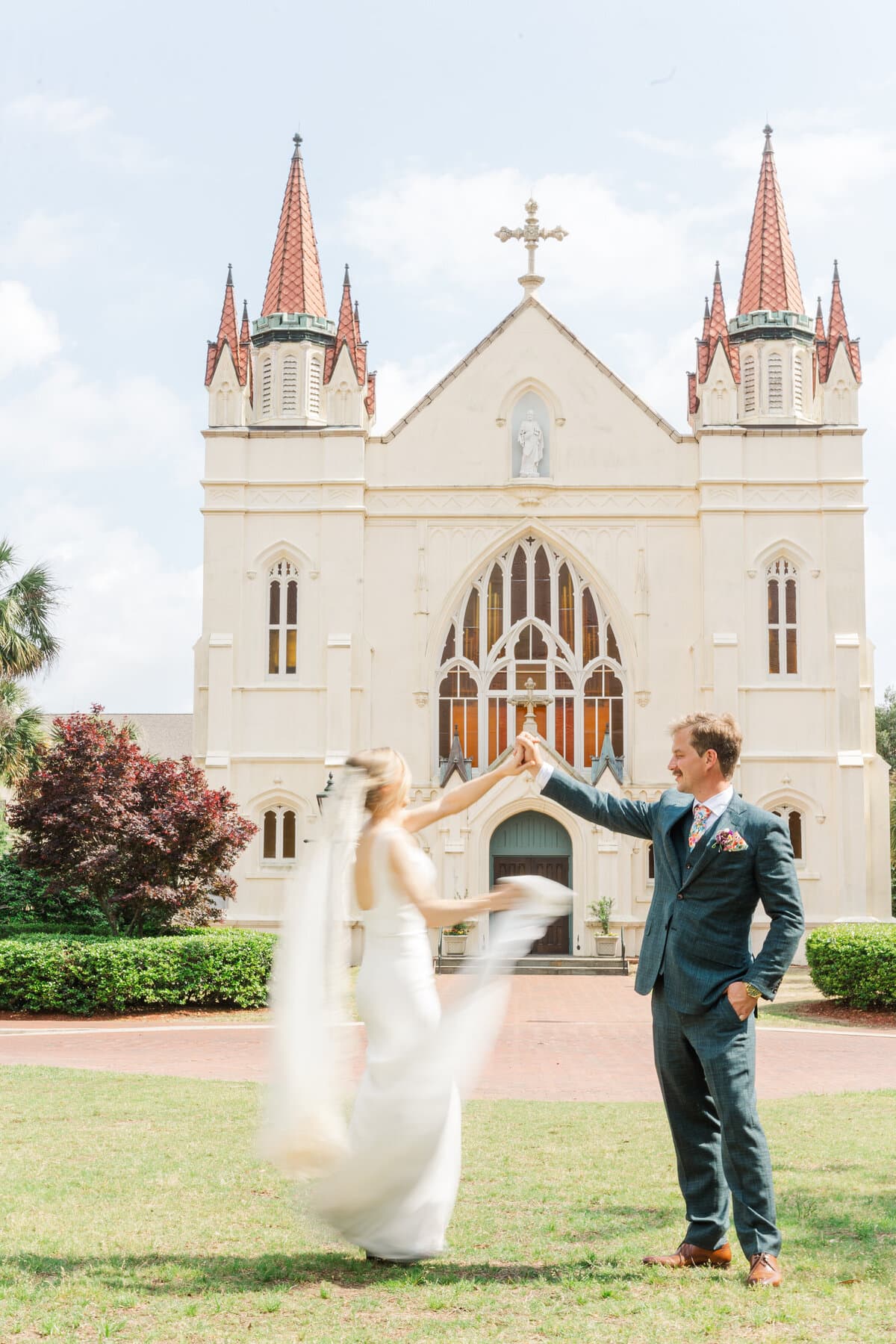 Newlyweds celebrating outside a white chapel
