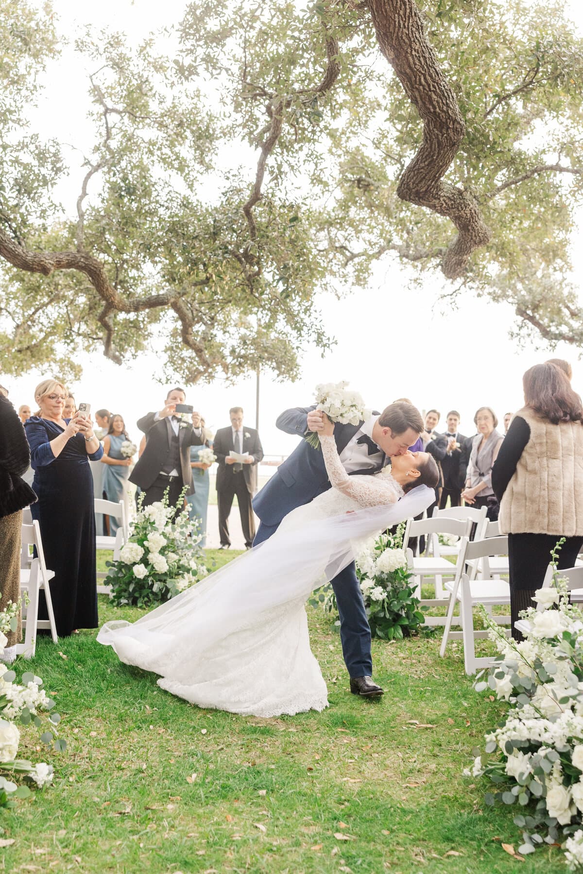 Newlyweds sharing a kiss at their outdoor ceremony