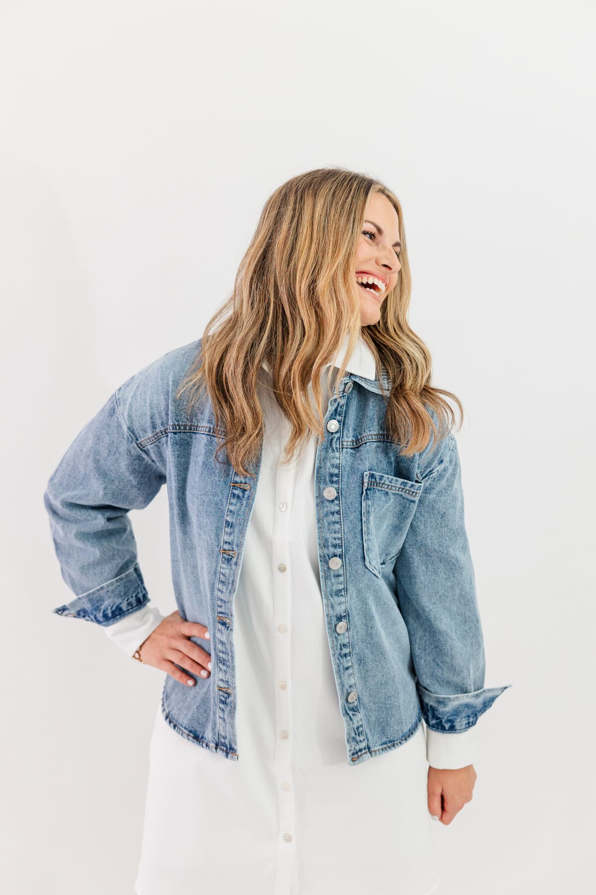 Jennie laughing in a denim jacket