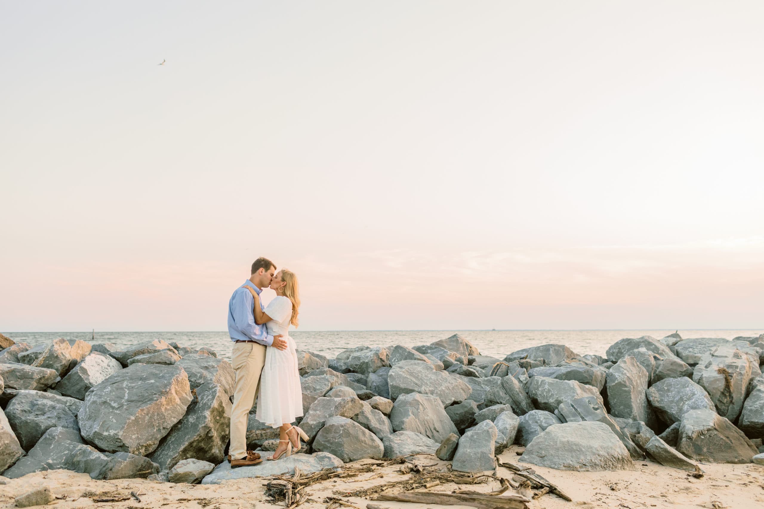 grand hotel engagement photo on the rocks at the bay