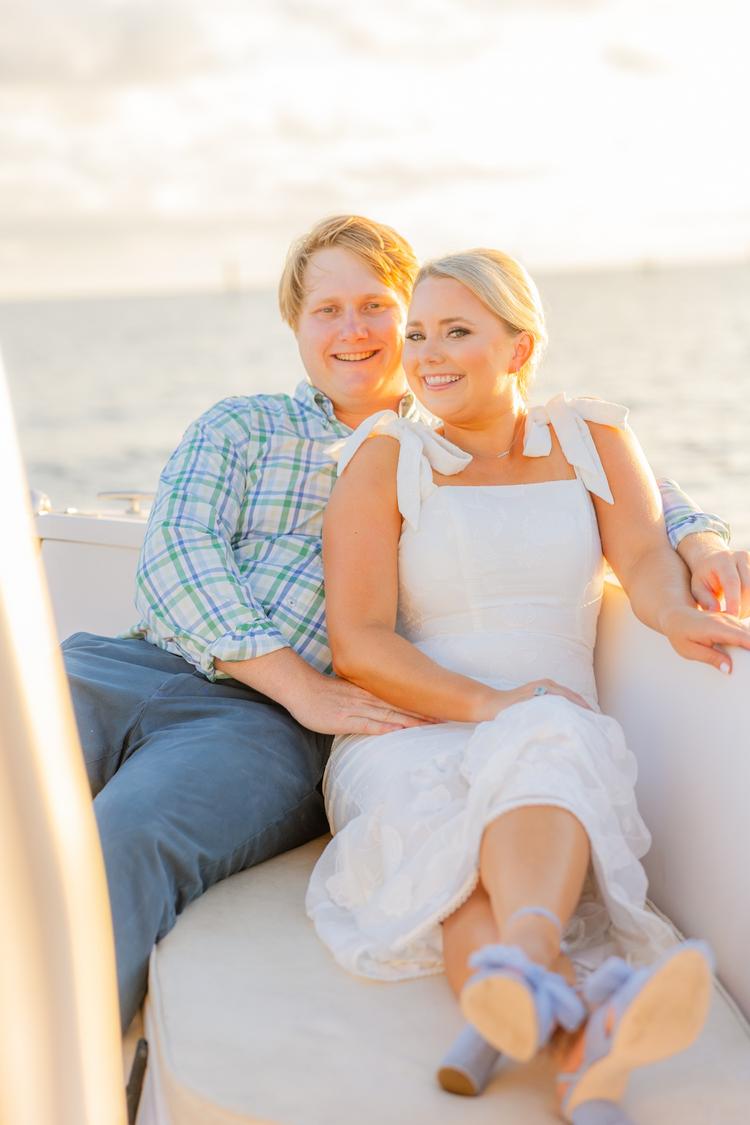 Romantic couple Audrey and Lyon, bathed in soft sunlight, share a loving moment beneath the mossy oak trees at the picturesque Grand Hotel in Fairhope.