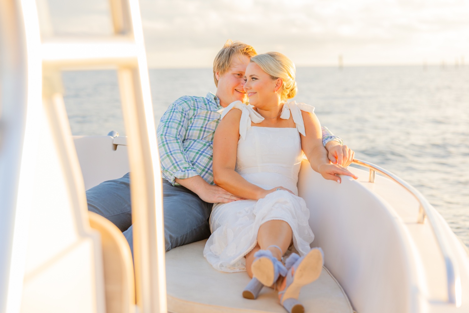 Romantic couple Audrey and Lyon, bathed in soft sunlight, share a loving moment beneath the mossy oak trees at the picturesque Grand Hotel in Fairhope.