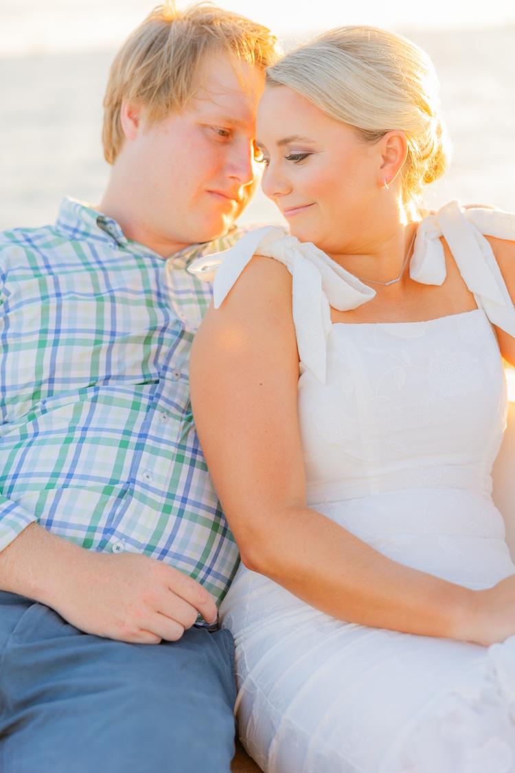 Romantic couple Audrey and Lyon, bathed in soft sunlight, share a loving moment beneath the mossy oak trees at the picturesque Grand Hotel in Fairhope.