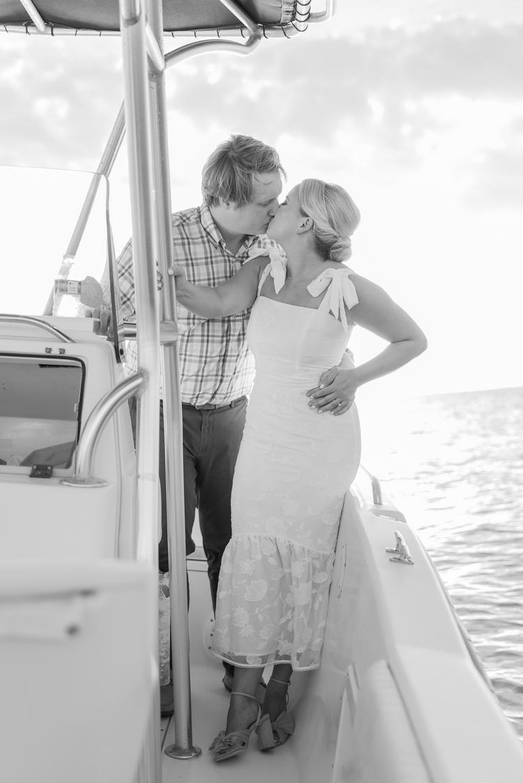 Romantic couple Audrey and Lyon, bathed in soft sunlight, share a loving moment beneath the mossy oak trees at the picturesque Grand Hotel in Fairhope.