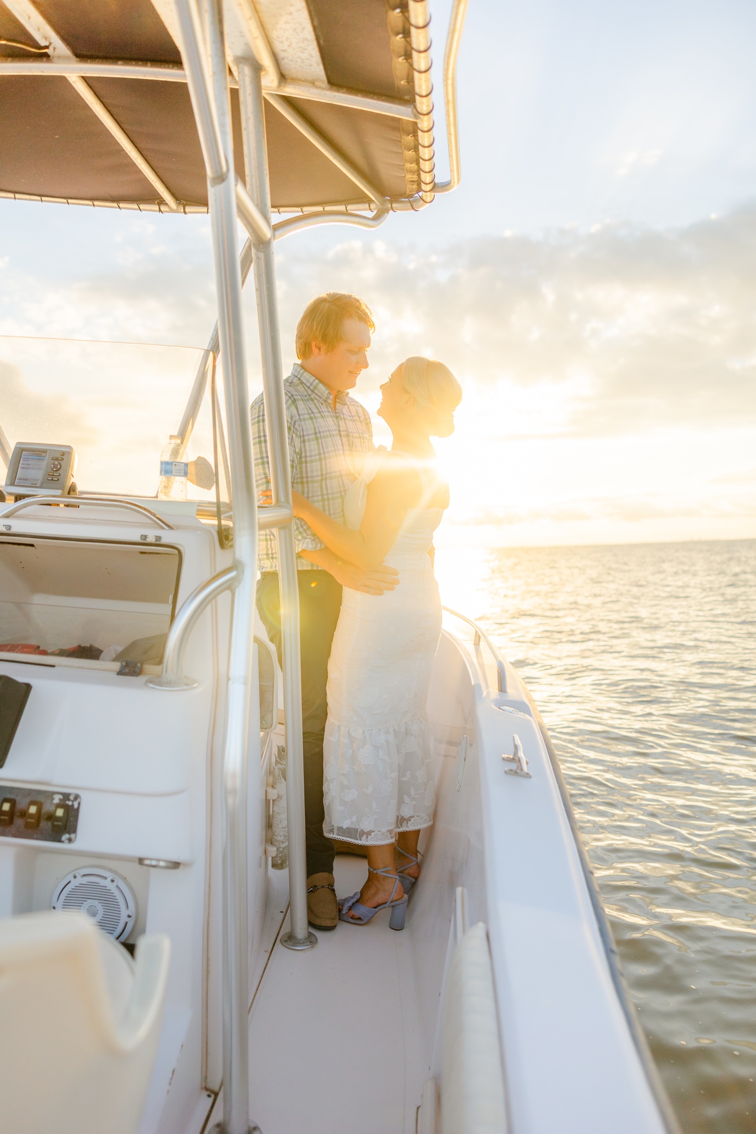Romantic couple Audrey and Lyon, bathed in soft sunlight, share a loving moment beneath the mossy oak trees at the picturesque Grand Hotel in Fairhope.