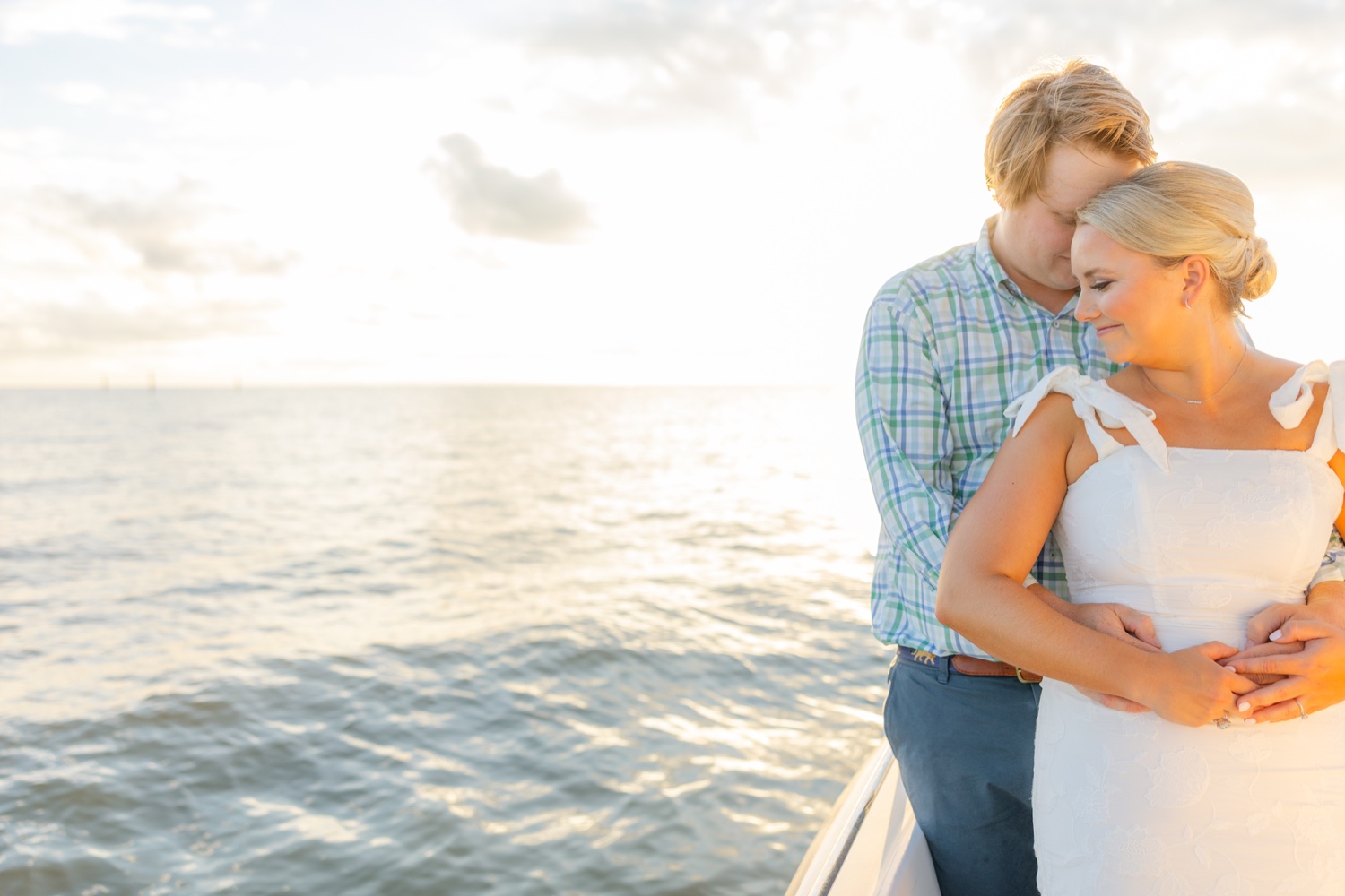 Romantic couple Audrey and Lyon, bathed in soft sunlight, share a loving moment beneath the mossy oak trees at the picturesque Grand Hotel in Fairhope.