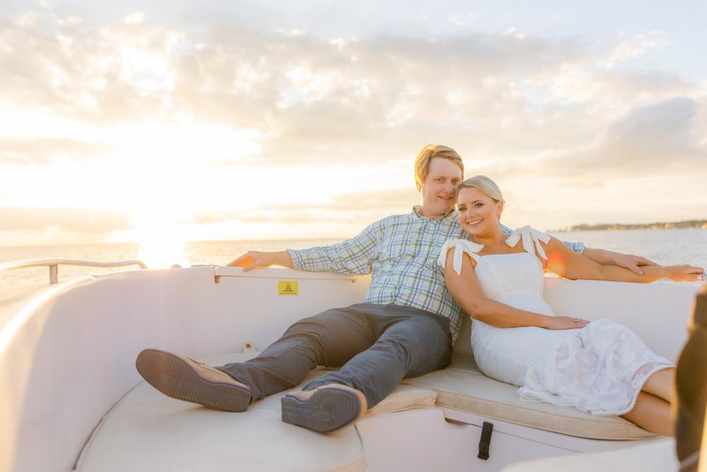 Romantic couple Audrey and Lyon, bathed in soft sunlight, share a loving moment beneath the mossy oak trees at the picturesque Grand Hotel in Fairhope.