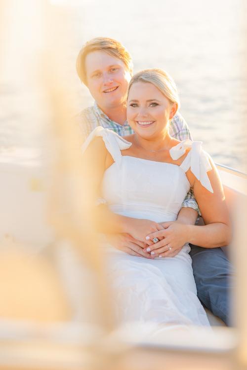 Romantic couple Audrey and Lyon, bathed in soft sunlight, share a loving moment beneath the mossy oak trees at the picturesque Grand Hotel in Fairhope.