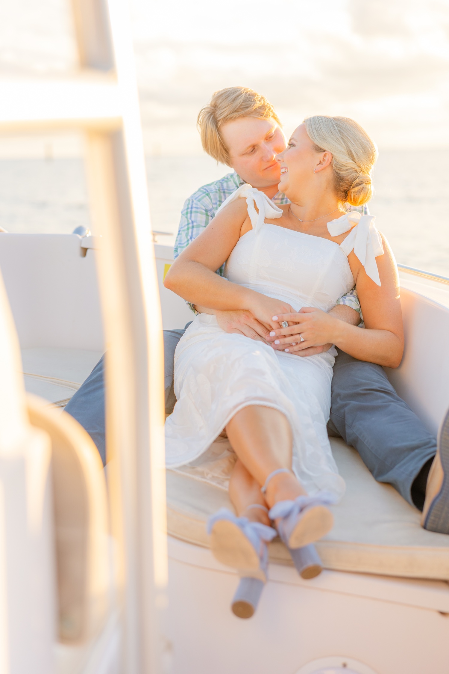 Romantic couple Audrey and Lyon, bathed in soft sunlight, share a loving moment beneath the mossy oak trees at the picturesque Grand Hotel in Fairhope.