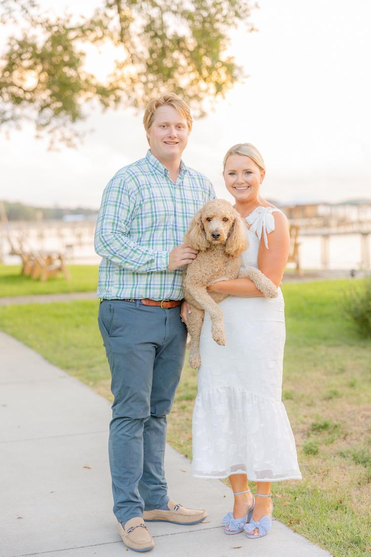 Romantic couple Audrey and Lyon, bathed in soft sunlight, share a loving moment beneath the mossy oak trees at the picturesque Grand Hotel in Fairhope.