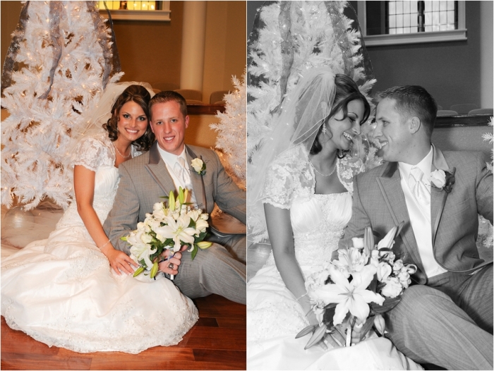 Jennie and Andrew seated together for wedding portraits beside white Christmas trees